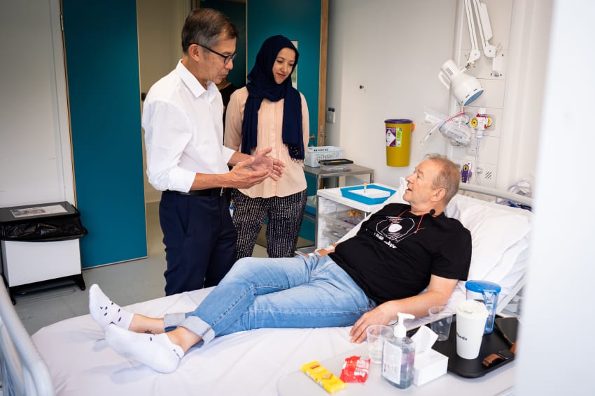 UCLH consultant medical oncologist Siow Ming Lee and Dr Sarah Benafif talking with patient Janusz Racz before receiving an injection of a BioNTech mRNA cancer immunotherapy for non-small cell lung cancer (NSCLC) - known as BNT116
