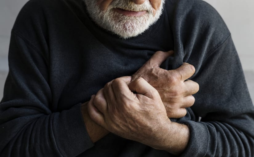 Man clutching chest