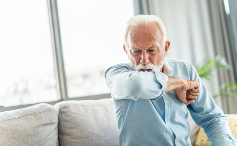 Older man coughing