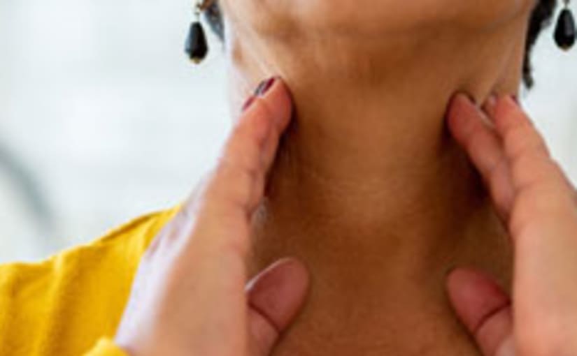Woman with hands on sore neck