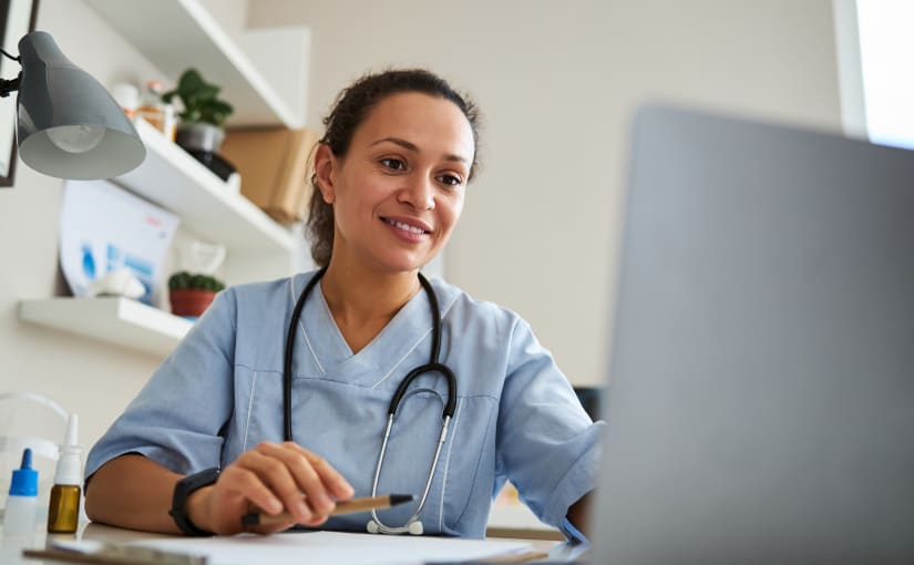 Female doctor looking at her computer at CME for FY1 and FY2 doctors
