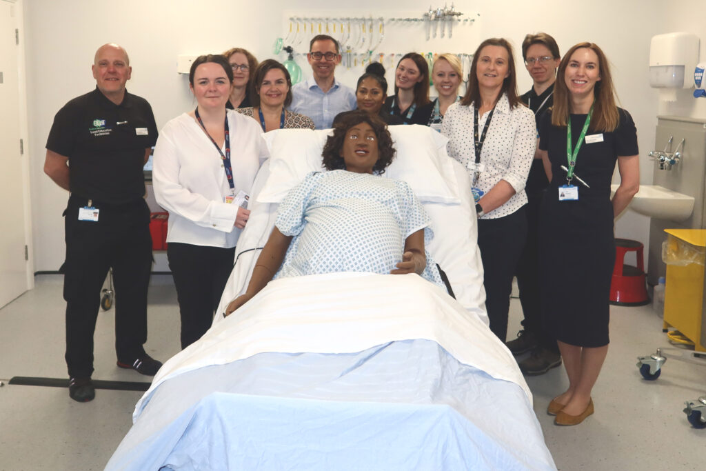Health professionals around a manikin